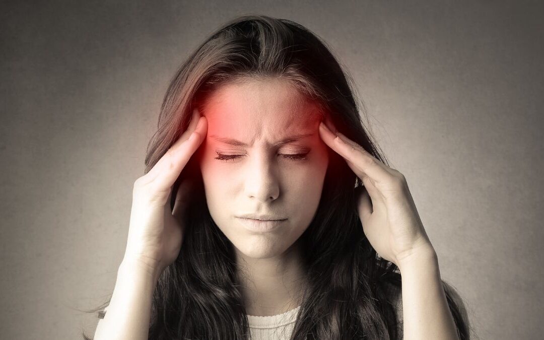 A Woman Holding Her Head With Her Eyes Closed